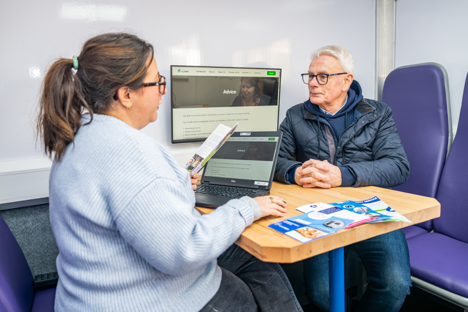 A meeting happening in the Support on the Move bus