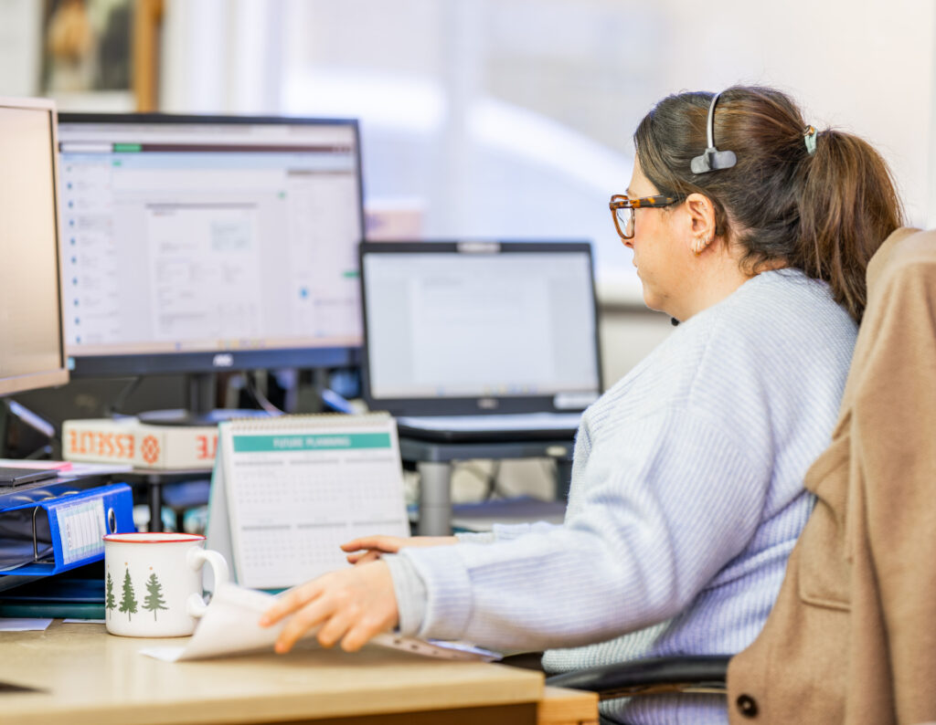 Horsham Matters employee working at desk